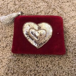 Red velvet zippered bag with gold sequined heart.